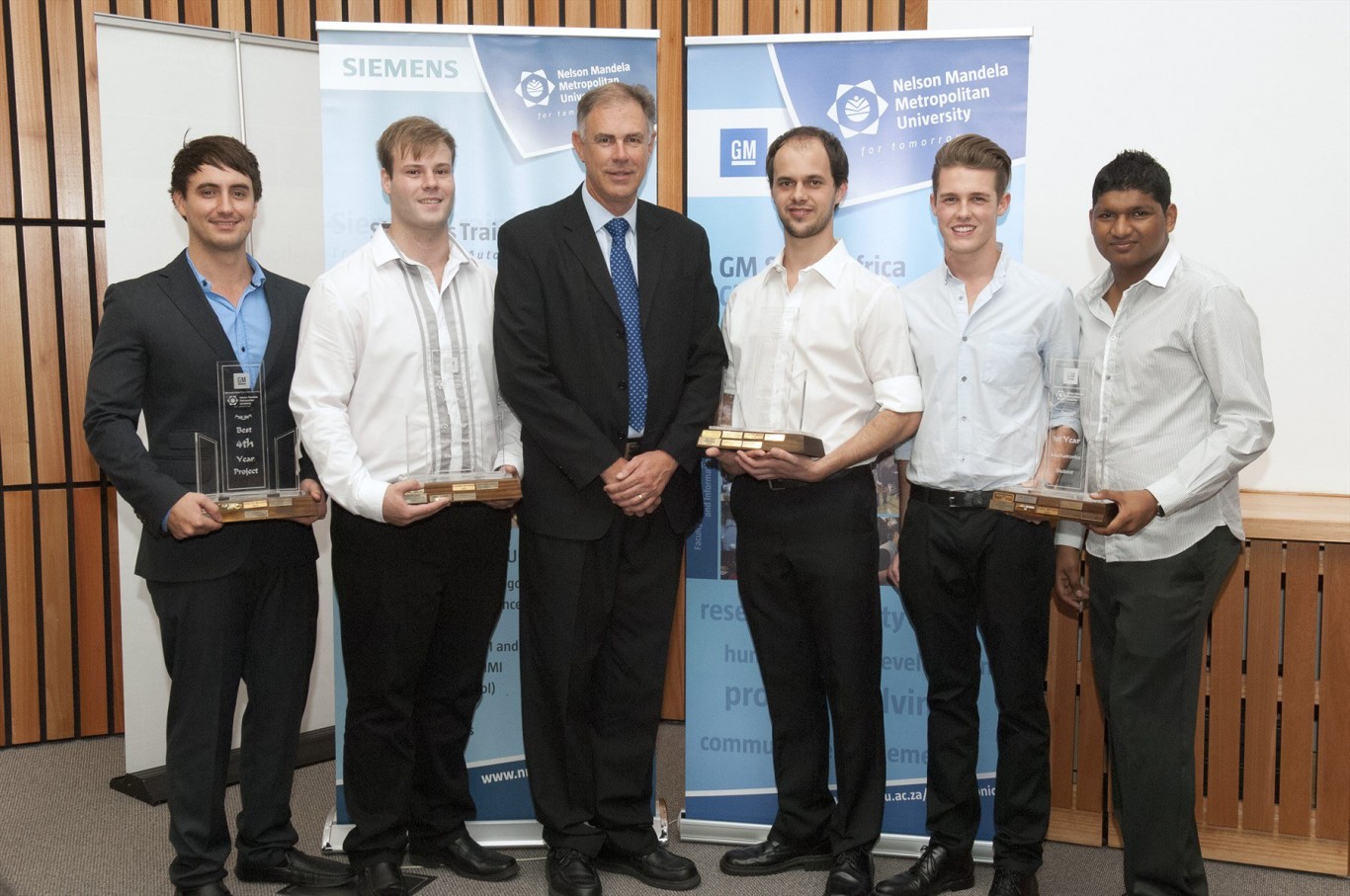 Obtaining Merit Awards for their fourth year projects in Mechatronics Engineering in 2015, are from left: Scott Burton, Theo Weyers, Mr Wayne Osborne GMSA Training and Organisational Development Manager), Hein Swanepoel, Richard Kirton and Shaish Gopichand.
